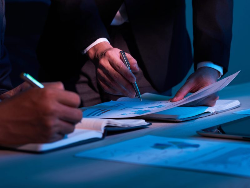 Close-up image of business partners working with financial documents